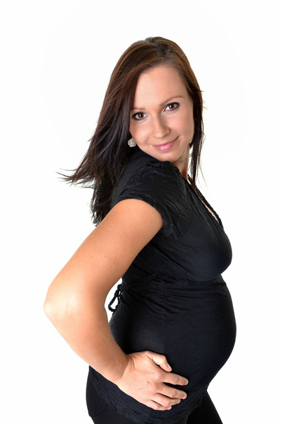 Pregnant woman caressing her belly over white background - Foto, imagen