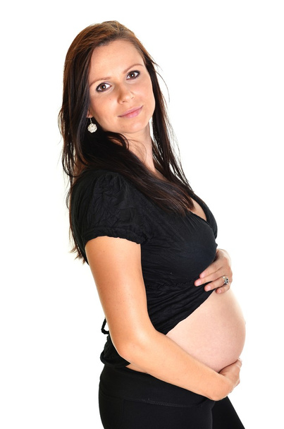 Pregnant woman caressing her belly over white background - Fotoğraf, Görsel