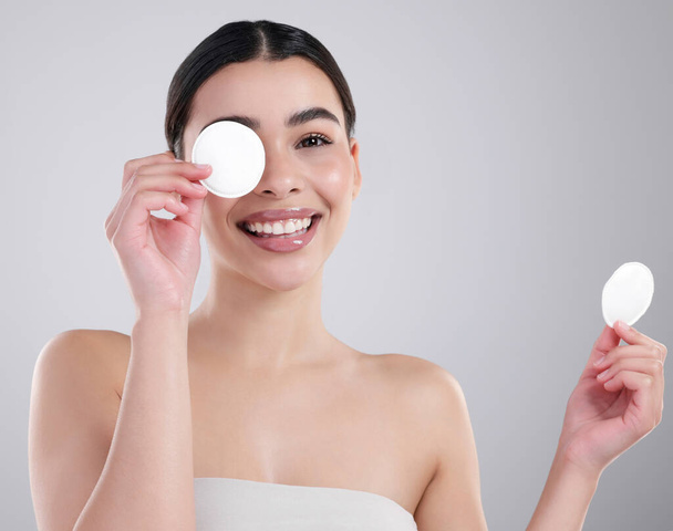 Woman, portrait and happy with cotton pad for skincare, dermatology and wellness in studio. Girl, smile and cosmetic for beauty, makeup remover and cleanser on white background mockup space in France. - Photo, Image