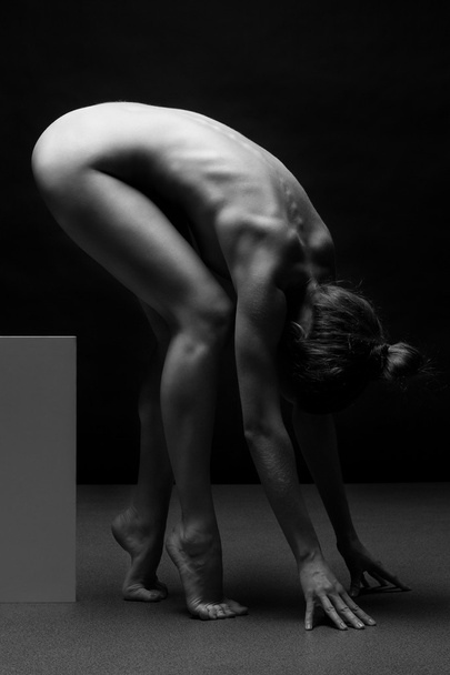Beautiful body of young woman over dark background - Valokuva, kuva