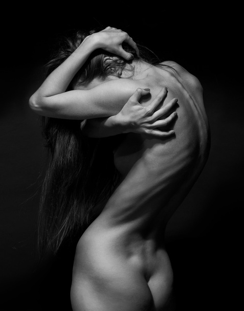 Beautiful body of young woman over dark background - Photo, Image