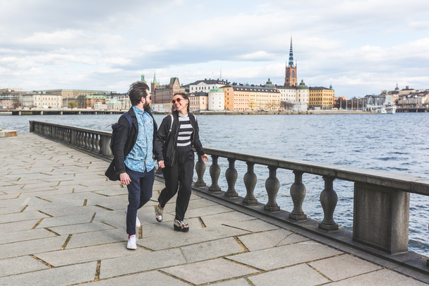 Young hipster couple running hand in hand in Stockholm - Fotografie, Obrázek