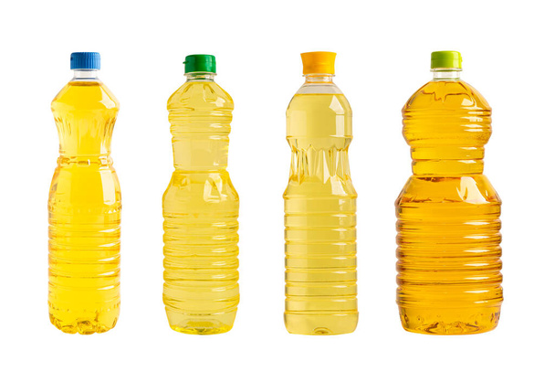 Рослинна олія в різних пляшках для приготування їжі ізольована на білому тлі. - Фото, зображення
