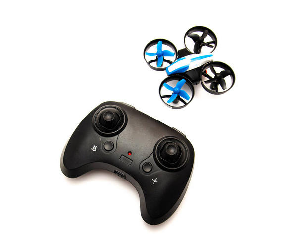 Indoor mini drone with joystick remote control radio, protection guard for propellers isolated on white background, quadcopter auto hovering and flashing light indicator, toy for kids. Education - Photo, Image