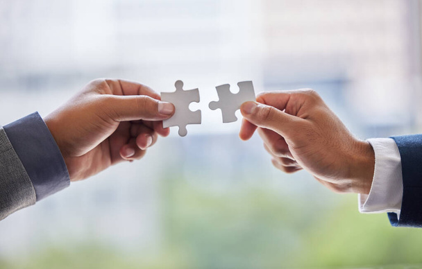 Hands, collaboration and business people with puzzle in office for partnership or synergy with joint effort. Crm, corporate and teamwork with unity in company or trust with employees in Switzerland - Photo, Image