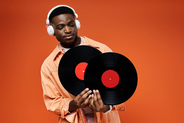 Stylish black man with headphones holding a record. - Photo, Image