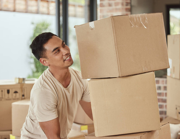 Man, box and happy in new home, logistics or real estate for moving, beginning and commitment for mortgage. Delivery, and cardboard package and excited for property or apartment and renovation. - Photo, Image