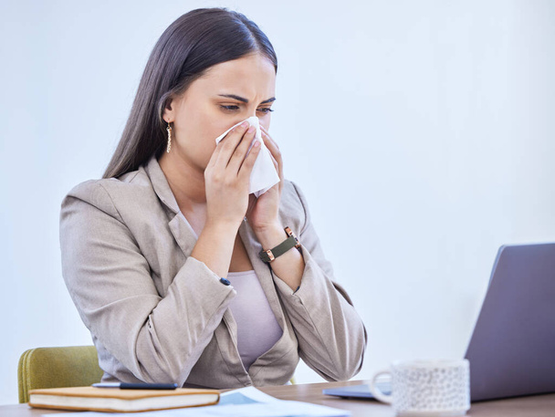 Sick, woman and nose with tissue in office for flu virus, bacteria or allergies at corporate job. Health, laptop and professional person with toilet paper at work for sinusitis, congestion and safety. - Photo, Image