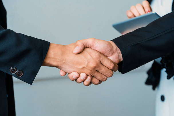 Business people agreement concept. Businessman do handshake with another businessman in the office meeting room. uds - Photo, Image