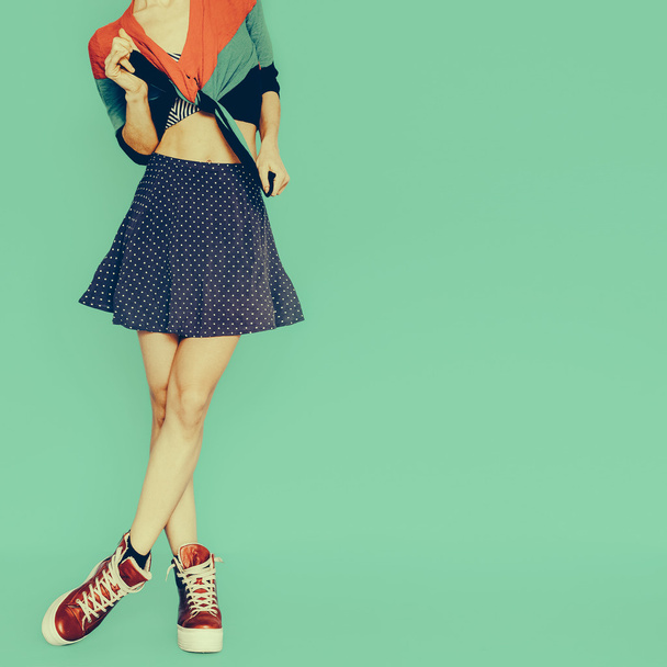 Playful girl in skirt polka dot on blue background. vintage styl - Photo, image
