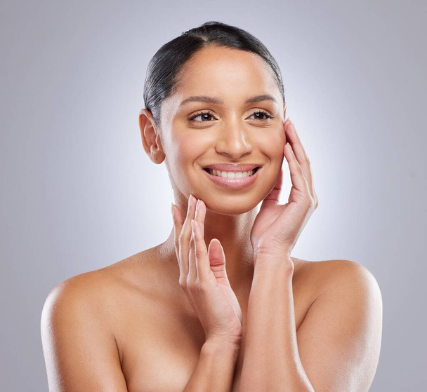 Cosmetics, smile and woman with skincare in studio for natural beauty, dermatology and self care. Female person, happy and confident with pride for spa treatment, glow and shine on gray background. - Foto, Imagen