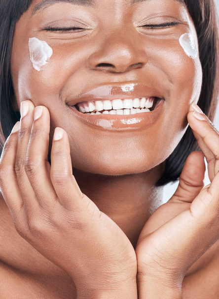 Happy black woman, skincare and facial treatment with cream for beauty, hydration or moisturizer Closeup or face of African, female person or model with smile for lotion, cosmetics or healthy skin. - Foto, Imagem