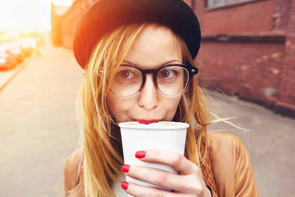 stylish woman in glasses drinking coffee in morning sunshine - Фото, зображення