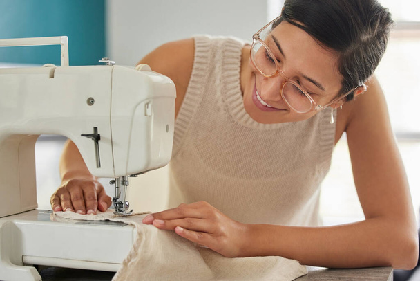 Smile, woman and sewing machine in apartment for small business, fashion design and pride. Female seamstress, creativity and fabric in home workshop for production, clothing and boutique tailor. - Photo, Image