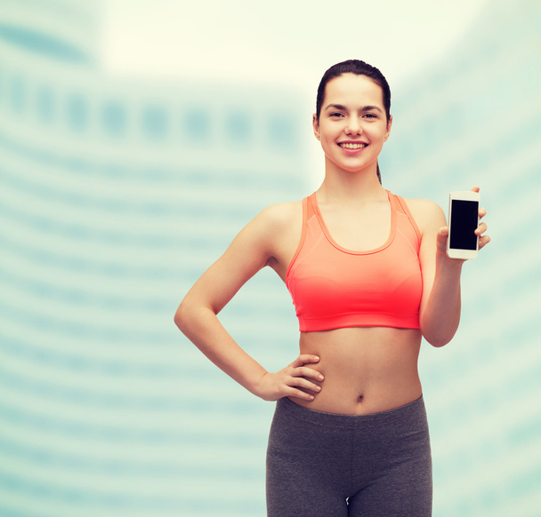sporty woman with smartphone - Foto, afbeelding