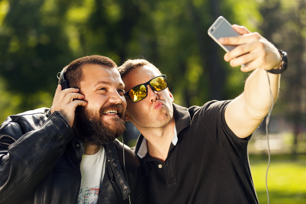 Δύο φίλοι λήψη μιας φωτογραφίας selfie με κινητό έξυπνο τηλέφωνο - Φωτογραφία, εικόνα