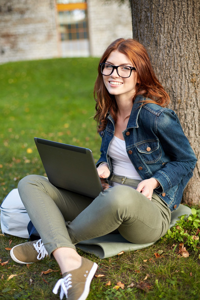 happy student girl writing to notebook at campus - Photo, Image