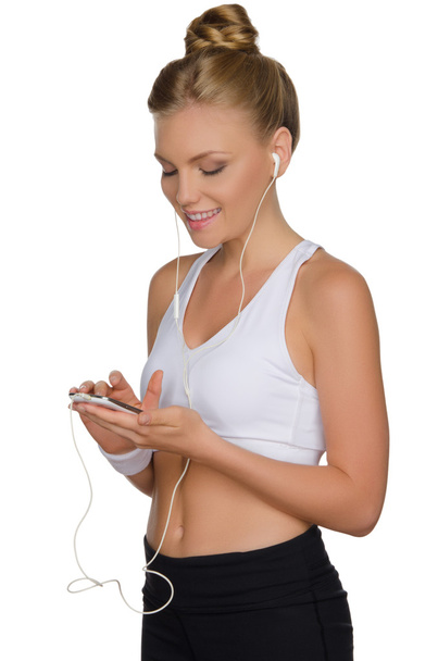 beautiful athletic woman with headphone and phone - Foto, Bild