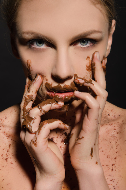 beautiful woman with chocolate on her face - Zdjęcie, obraz