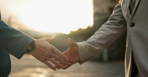Business people, sunset and handshake for partnership in city, networking and introduction outdoors. Professionals, dusk and welcome in recruitment or integration, closeup and hire for collaboration. - Footage, Video