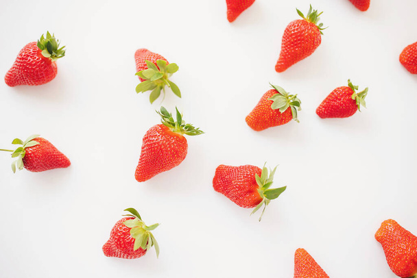 Fraises juteuses mûres sur fond blanc. modèle. Composition créative de fond d'été avec fraise. Concept de fruit minimal.  - Photo, image