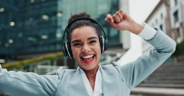 Businesswoman, headphones and dancing music for cellphone playlist, streaming or commute. Female person, happy and smartphone or urban city building in New York with internet, audio or stress relief. - Footage, Video