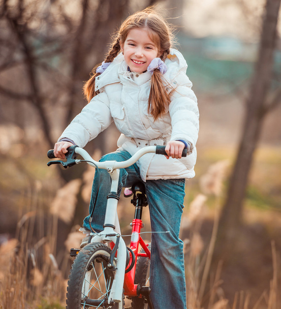 Little girl on  bicycle - 写真・画像