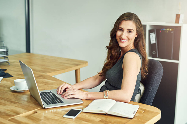Portrait, woman and laptop in workplace with corporate job for notebook, check email and reading online news. Female consultant, notes and tech in modern office for smile, internet and client advice. - Photo, Image