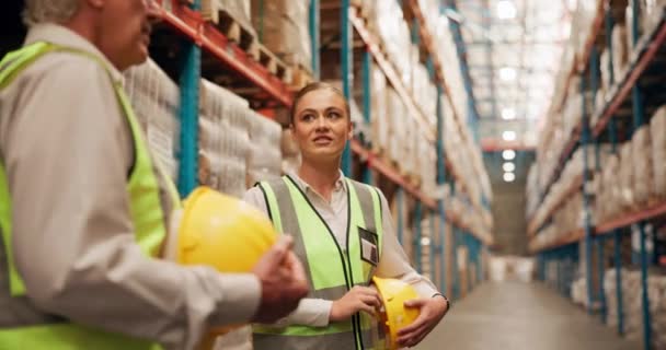 Talking, safety and woman in construction at warehouse with information, feedback and communication for team. Professional, worker and discussion of industry process or planning storage in factory. - Footage, Video