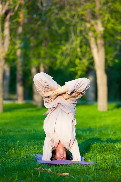Practicing yoga in the morning, with trees  background - Foto, Bild