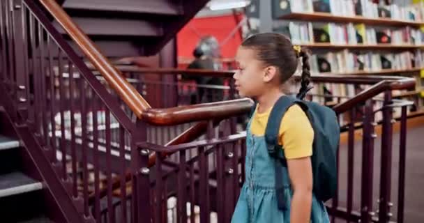 Girl, backpack or stairs in library, research or thinking of question, planning or learning books. Female child, bag or vision of study, back to school or academy as knowledge, information or idea. - Footage, Video