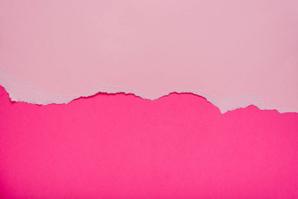 Torn pink paper on dark pink background. Space for text. - Photo, Image