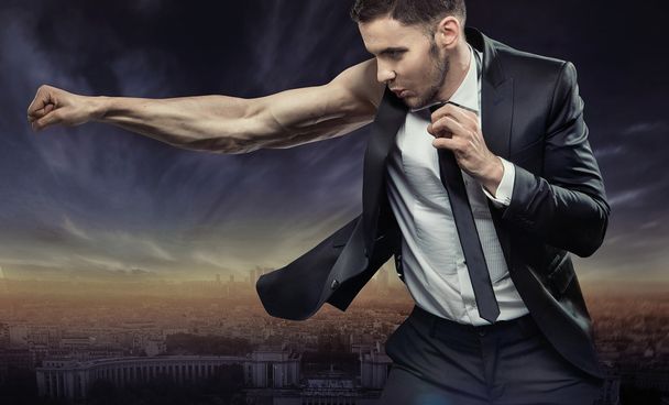 Strong and muscular businessman over the city - Foto, Bild