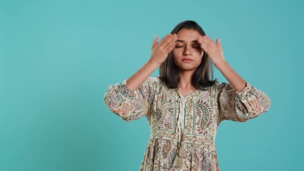 Woman covering eyes, ears and mouth, imitating three wise monkeys. Indian person doing don t see, don t hear and don t speak hand gesturing concept, studio background, camera A - Footage, Video