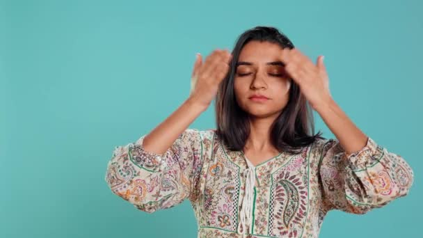 Woman covering eyes, ears and mouth, imitating three wise monkeys. Indian person doing don t see, don t hear and don t speak hand gesturing concept, studio background, camera B - Footage, Video