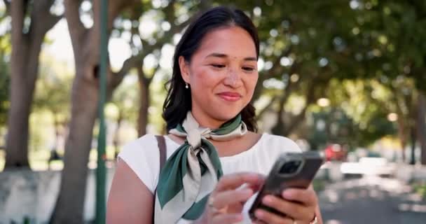 Nature, smile and business woman on a phone networking on social media, mobile app or internet. Happy, technology and professional female creative designer typing online email in outdoor park - Footage, Video