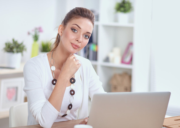 Portrait of a businesswoman sitting at  desk with  laptop - Zdjęcie, obraz