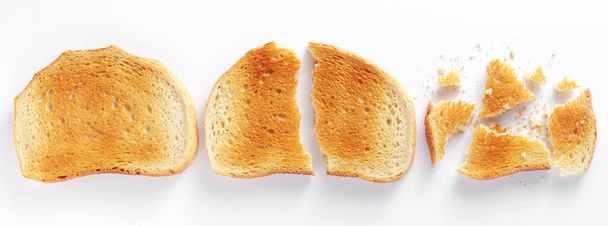 Pieces of toasted bread on a white background, top view - Photo, Image