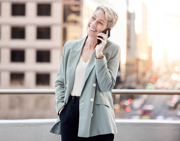 Business, thinking and mature woman with phone call on balcony for b2b, advice or client, communication and networking. Smartphone, planning and ceo conversation, deal or listening to investor pitch. - Photo, Image