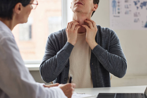 Allergiás vagy bőrbetegségben szenvedő férfi nyakvakarás közeli képe konzultáció a klinikán a bőrgyógyásznál - Fotó, kép