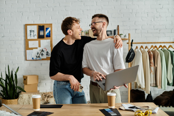 A gay couple collaboratively designs trendy attire in their designer workshop. - Foto, afbeelding