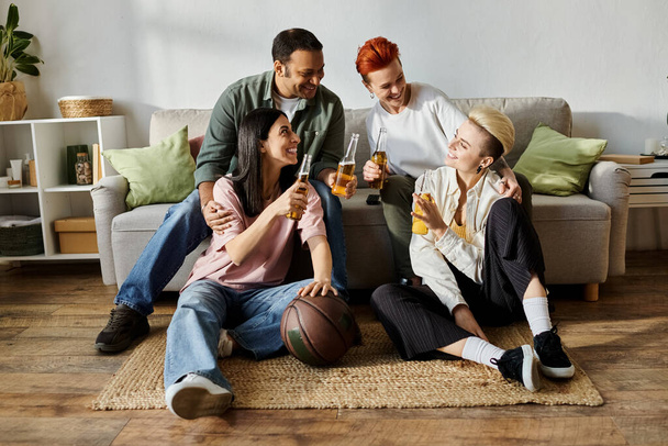 A group of friends, including a loving lesbian couple, sit together on a floor. - Photo, Image