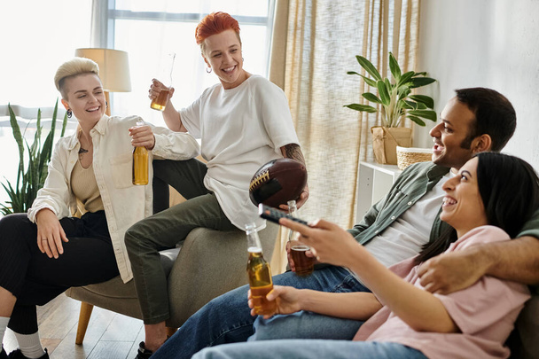 Diverse group of friends and loving lesbian couple relaxing in a warm living room setting. - Photo, Image