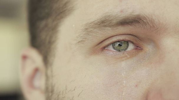 Crying man with tears on face close up. Emotions, depression, problem concept. Slow motion - Photo, Image