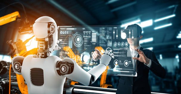 MLP Robot zmechanizowany i pracownik przemysłu pracujący razem w przyszłej fabryce. Koncepcja sztucznej inteligencji w procesie rewolucji przemysłowej i automatyzacji produkcji. - Zdjęcie, obraz
