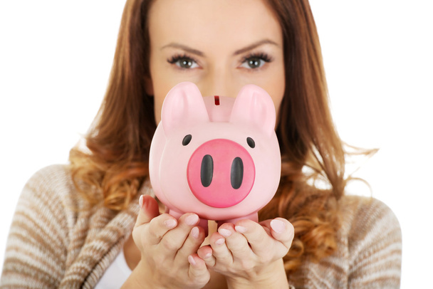Casual woman holding piggy-bank. - Foto, Imagen