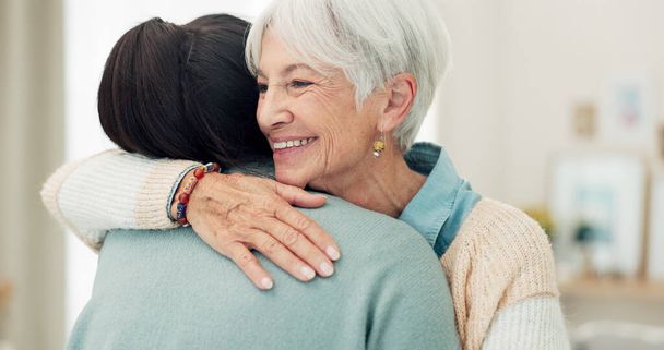 Happy senior woman, hug and elderly care for thank you, gratitude or support for caregiver at home. Mature female person or patient embracing medical or healthcare worker in trust, happiness or house. - Photo, Image