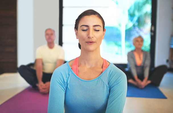 Female yoga instructor, elderly class and meditation in retirement center for health, relaxation and exercise. Woman, sitting and wellness in old age home for pensioners, pain relief and calm. - Photo, Image