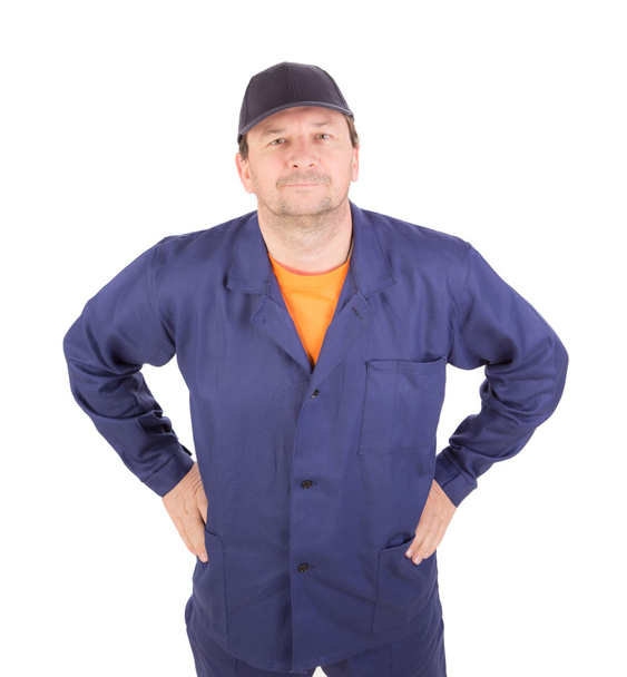 Man in working clothes with arms on waist. - Фото, зображення