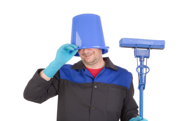 Man with mop and bucket on head. - Zdjęcie, obraz